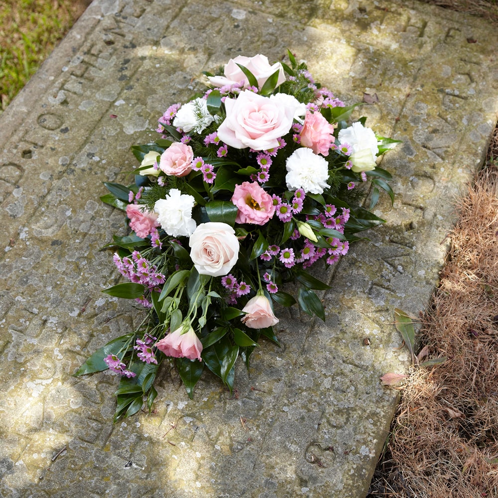 Pink funeral spray on a gravestone